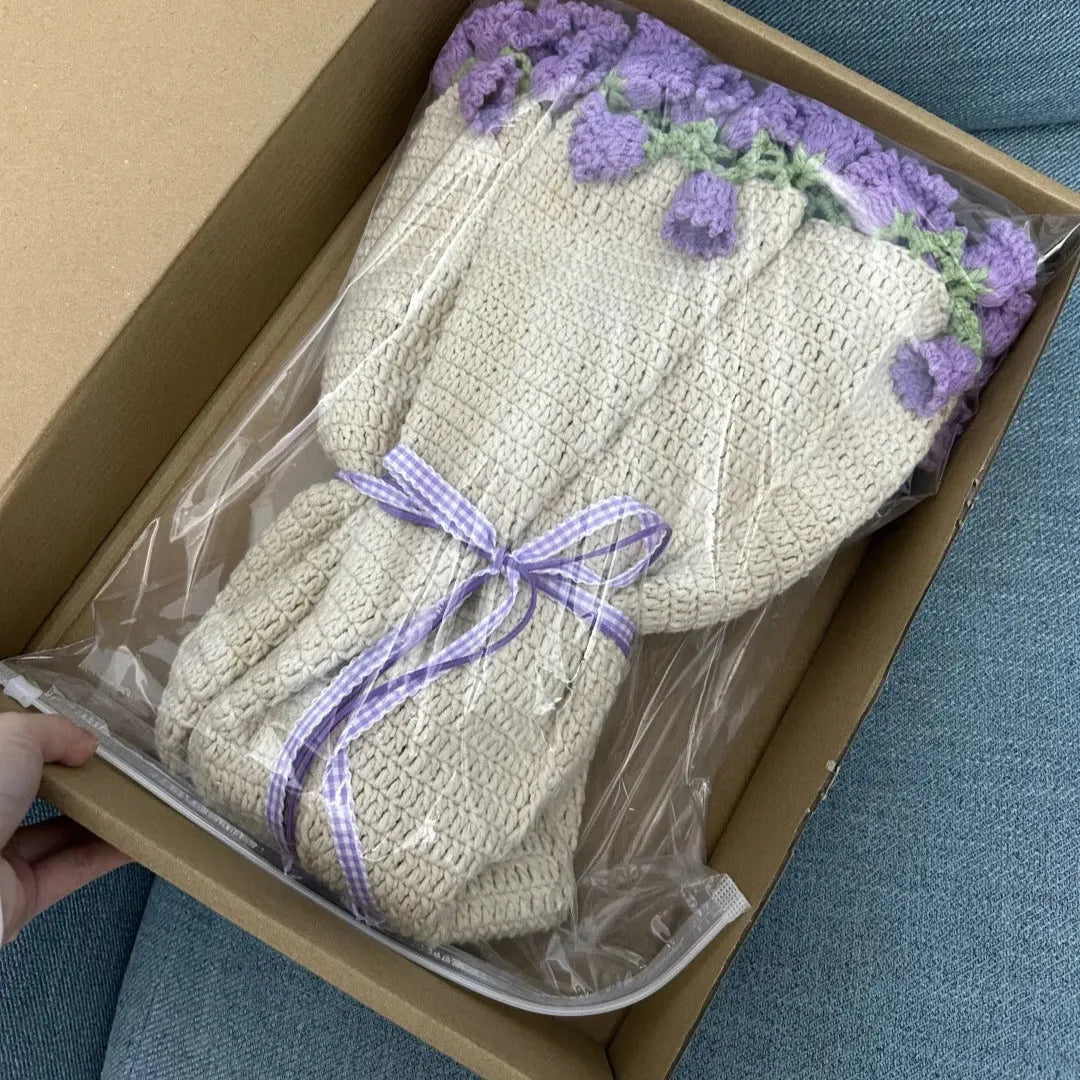 A folded lavender-themed crochet blanket tied with a purple ribbon and neatly packed in a cardboard gift box, ready for shipping